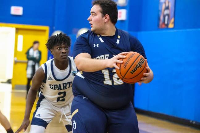 Sparta’s Brandon Joefield defends against Pope John’s Angelo Dillon.