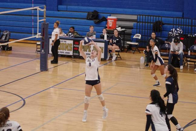 Pope John's Lauren Duffy taps the ball. She had four digs and nine assists.