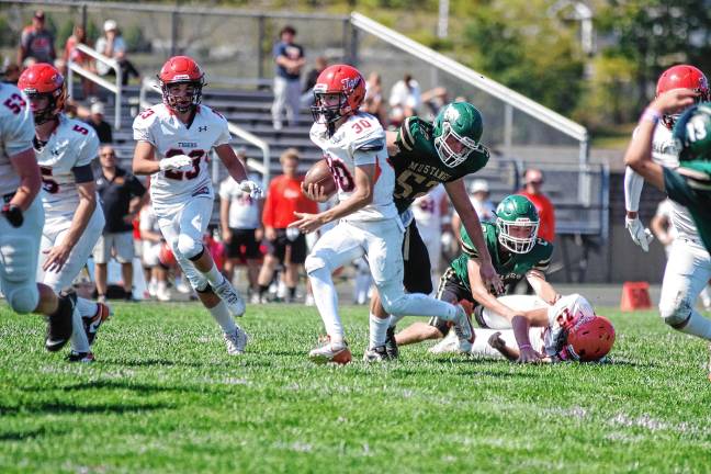 High Point tops Kittatinny, 14-7 <b>Hackettstown ball carrier Carter Grant runs through an opening in the Sussex Tech defense.</b>
