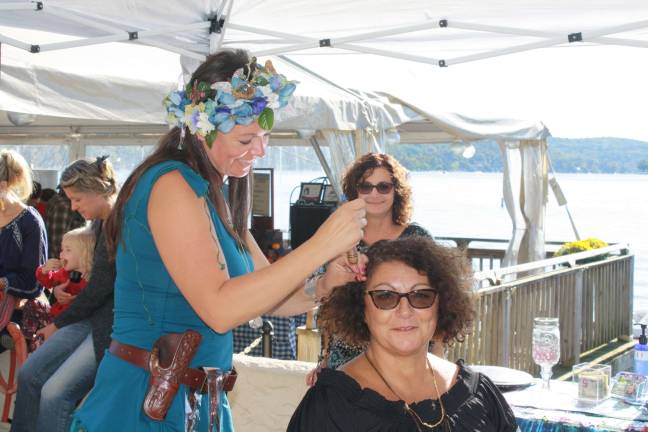 Kate Friesso applies Fairy Hair on Jeanne Hoskin at Sunday's Oktoberfest at Lake Mohawk Country Club. Photos by Rose Sgarlato