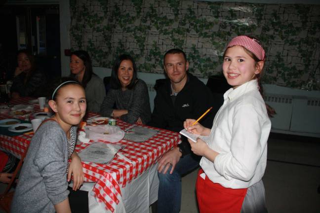 Kids serve parents at Annual Spaghetti Dinner Server Milly Dobbs takes an order for her family: sister Malaya and Mom and Dad, Michelle and Jason.