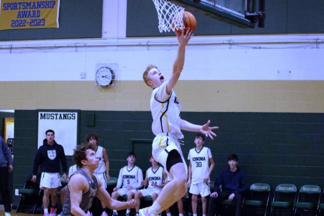 Koinonia's Benjamin Touhill goes airborne during a shot in the first half.