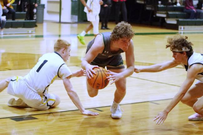 Sussex Tech's Nathan Carter moves the ball between two opponents. He scored four points and grabbed two rebounds.