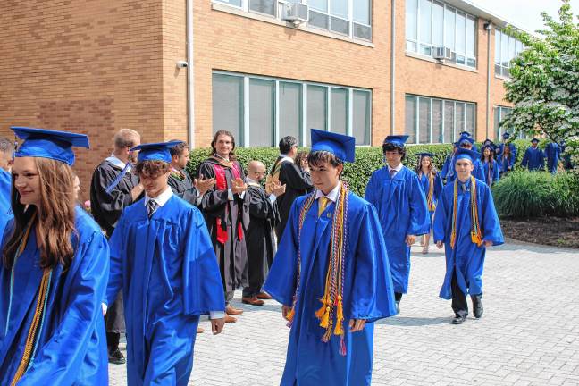 Photos: Pope John XXIII Regional High School graduation Faculty applaud as the graduates enter the gym for the ceremony.