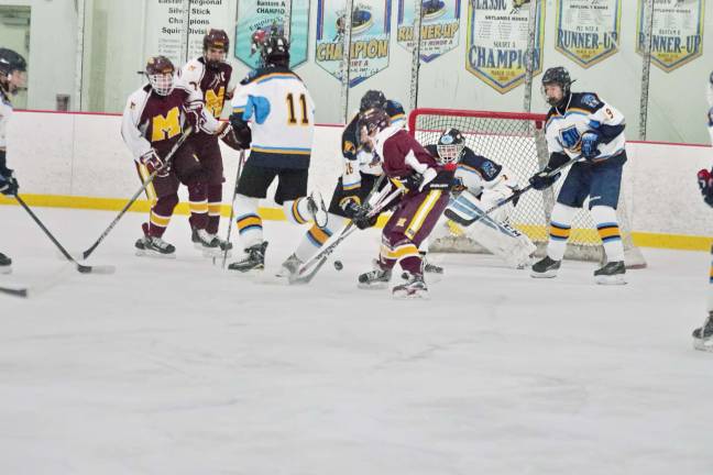 Madison bests Sparta-Jefferson on the ice The puck attracts a lot of traffic near the Sparta-Jefferson United goal post in the first period. Photos by George leroy Hunter