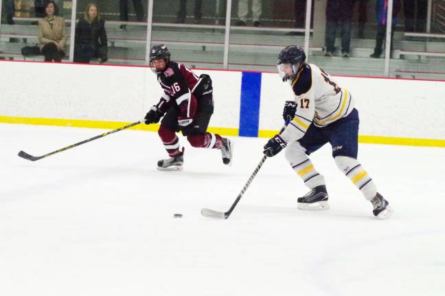 Pope John's beats Morristown-Beard on the ice Pope John's Artem Buzoverya controls the puck as Morristown-Beard's Thomas Dempsey keeps pace. Buzoverya scored one goal. Photos by George Leroy Hunter