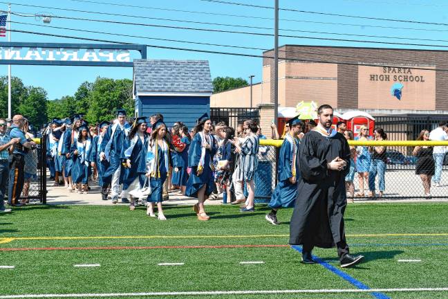 Photos: Sparta High School graduation Ryan Shafer, vice principal at Sparta High School, leads members of the Class of 2025 onto the field for graduation.