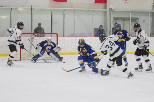 The puck moves toward the goal after being struck by Kinnelon/Jefferson/Sparta United's Joey Kopec (34).