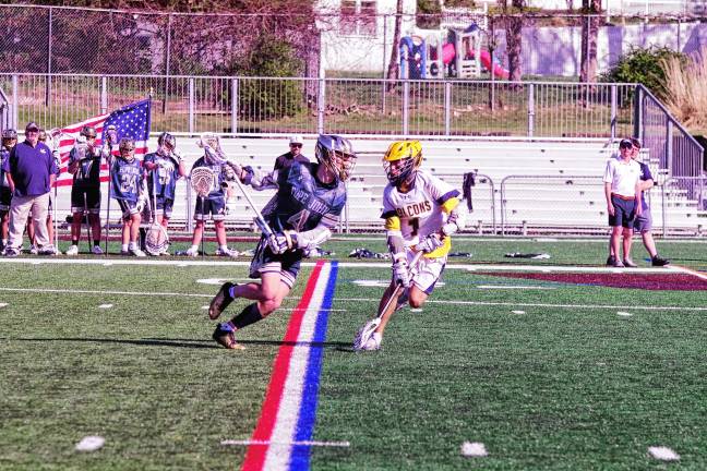 Sports roundup: Lions advance to H/W/S quarterfinal Pope John's Peyton Fox (4) runs with the ball as he faces Jefferson's Calen Reid on April 28. The Lions won, 12-4, and Fox scored two goals. (Photos by George Leroy Hunter)