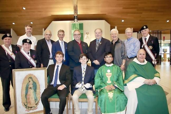 Pastor Father Vidal Gonzales and Deacon Bruce Olsen are joined by the Saint Kateri Squires and Knights along with the Dominick Calabrese Assembly color corps celebrate after the mass and ceremony. (Photo provided)