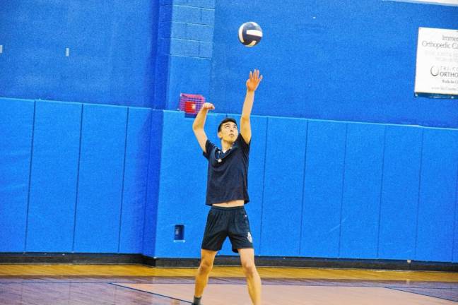 Pope John's Henry Czarnecki in the midst of a serve.