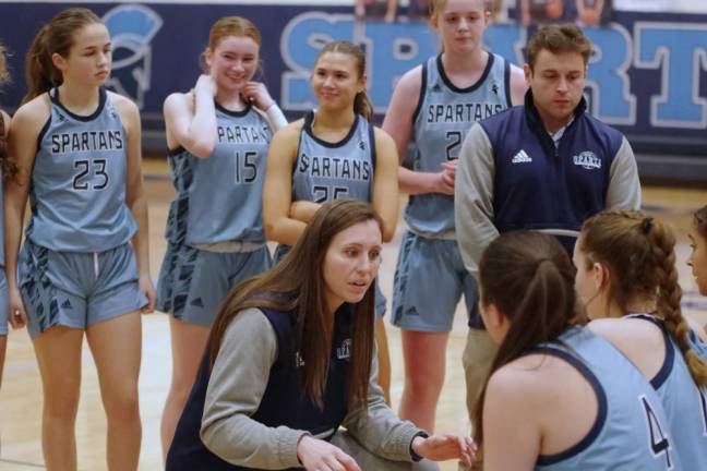 Sparta High School girls basketball head coach Kristina Danella, center, talks to the Spartans during a break.