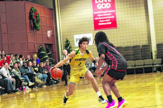 Veritas guard Evan Milanesi dribbles the ball. He scored 15 points against Harmony Christian. (Photo by George Leroy Hunter)