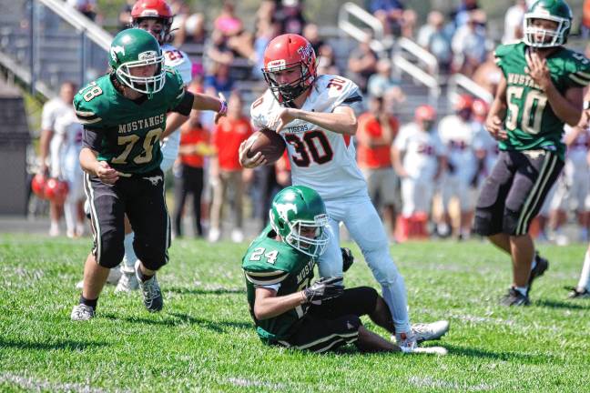 High Point tops Kittatinny, 14-7 <b>ST1 Hackettstown ball carrier Carter Grant is tackled by Sussex Tech defender Anthony Caroleo in their game Saturday, Sept. 13. The Mustangs lost, 51-0, at home.</b>