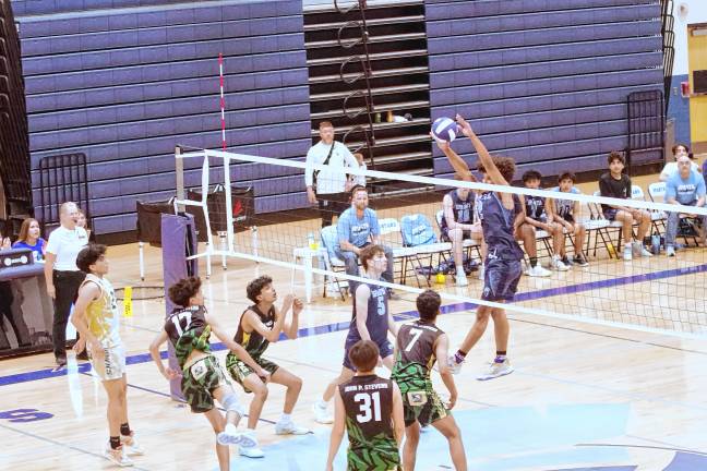 Sports roundup: Pope John wins H/W/S title Sparta's Diandre Carr intercepts the ball above the net.