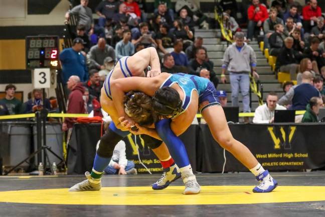 Troy Schmitzer leans against his coaches, John Procoppio and Frank Battaglia, after a challenging and exhausting match.