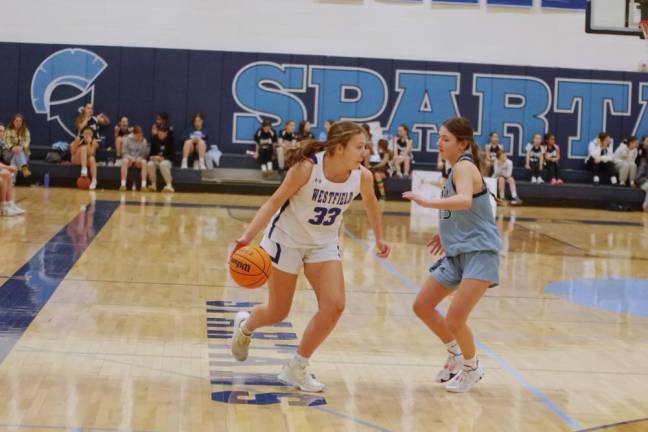 Westfield's Lucy Burke dribbles the ball while covered by Sparta's Alyssa Ciaburri. Burke scored three points and grabbed one rebound.