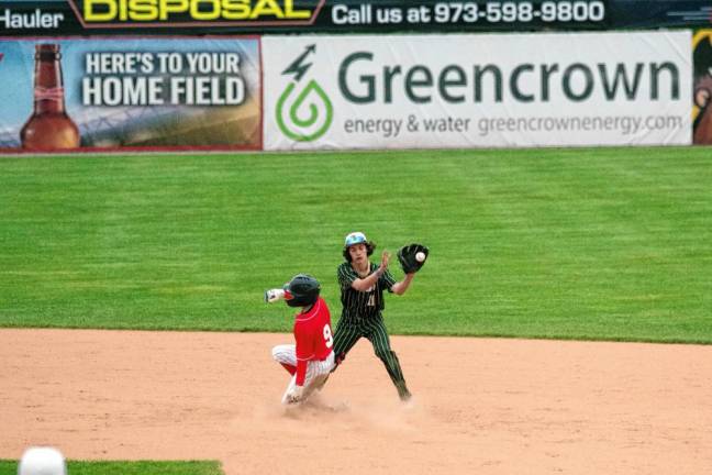 In the first inning, Belvidere runner Christopher Knight slides safe onto second base as the ball arrives to the glove of Sussex Tech infielder Gavin Gardner too late.