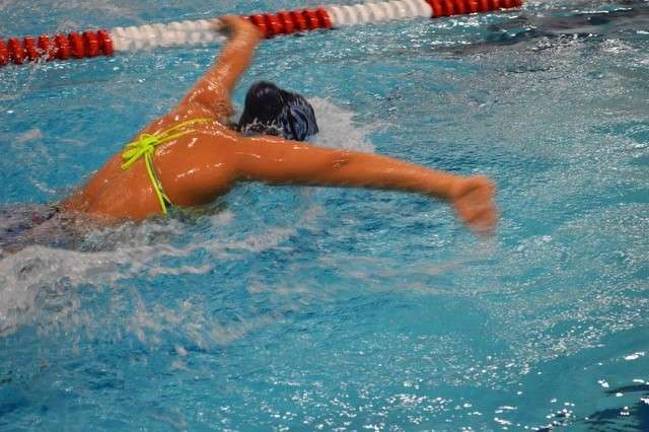 Sparta HS girl swimmers look ahead Freshman Miranda Doller does the 100M Fly in 1:02.