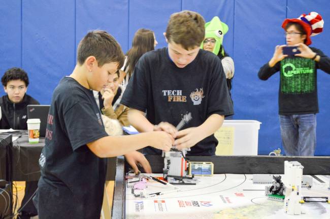 Newton Robotics hosts FIRST Lego League Qualifiers event Long Pond School Team "Tech Fire" setting up their robot to play the game PHOTOS BY LIAM OAKES