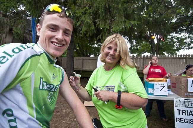 Triathlon draws athletes from 13 states From left, Dan Hutchinson of Sparta gets his number applied by Ginny Pinko of Sparta
