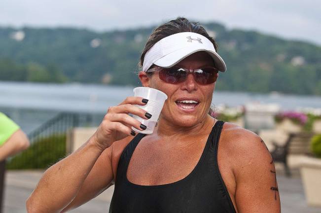 Triathlon draws athletes from 13 states First female finisher Lauren Huffman of Culver Lake, Branchville, enjoys a cup of water after the triathalon.
