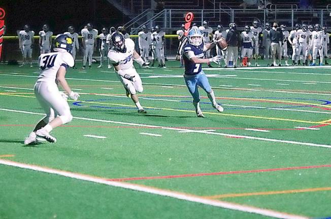 Sparta quarterback Brendan Cina is about to throw the ball in the second quarter. Cina passed for 69 yards and achieved one rushing touchdown.