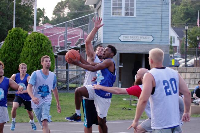 Team Melville's Samir Wheeler moves the ball towards the hoop. Wheeler scored 20 points. Wheeler is a graduate of Newton High School. He plays basketball at Sussex County Community College.