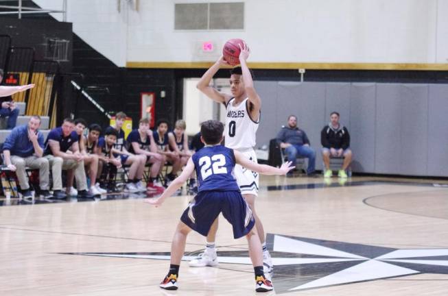 Wallkill Valley's Ivan Hicks looks for an open teammate to pass the ball to while covered by Pope John defender JackSakowski in the fourth quarter. Hicks grabbed 5 rebounds, made 3 assists and scored 8 points.