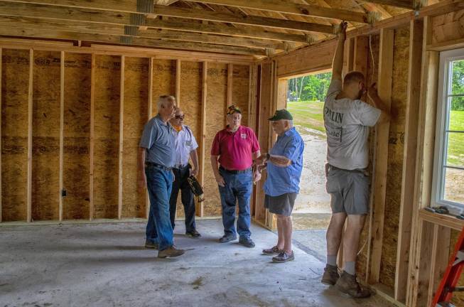 Tom Andrews, Trustee of the Northern NJ Veterans Memorial CEmetery, leads a tour of the new building.