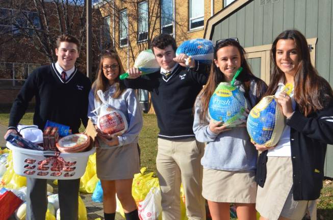 Students helped distribute Thanksgiving meal items.