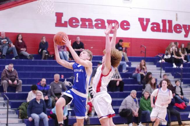 Kittatinny's Brian Plath raises the ball towards the hoop during a shot while covered by Lenape Valley's J.J. Worthington in the second half. Plath scored 19 points.