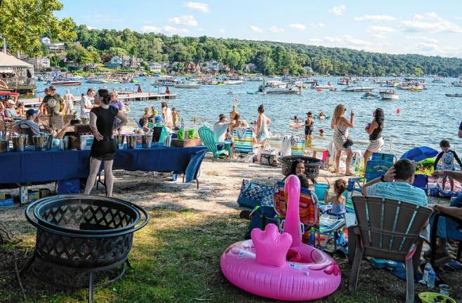 FloatFest 2024 People on boats in Lake Mohawk and on the beach enjoy FloatFest on Saturday, Aug. 10 in Sparta. Ten bands performed from noon to 9 p.m. There also were tasting tables and a food truck. (Photo by Nancy Madacsi)