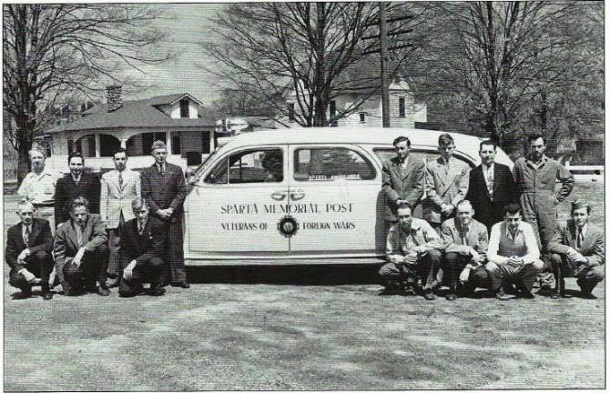 Photo courtesy of Vince Householder Sparta VFW members gather around the ambulance that responded to medical emergencies for many years.