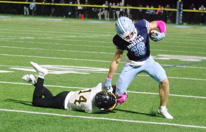 Highlanders rout Spartans, 31-0 Sparta wideout Christian Brevig tries to break free from the grasp of West Milford defensive back Patrick Foley (14).