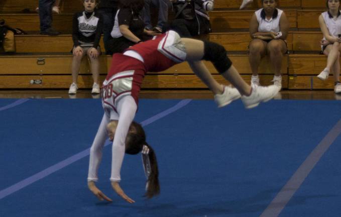 Rah, rah, rah Kristen Sansone of Our Lady of the Lake JV Cheer Team Warms up her back hand spring during a tumble run.