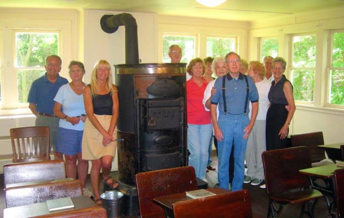 A tour group of students who attended the one-room schoolhouse and their friends visit the school during one of the tours. (Photo courtesy of the Vernon Historical Society)