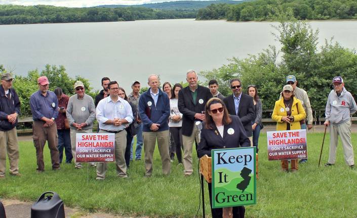 Activists rally for NJ water supply With Spruce lake reservoir in the background, Julia Somers, executive director of the New jersey Highlands Coalition, introduces the speakers at the rally, from left, in the row directly behind Somers (between the signs) are Ed Potosnack of NJ Keep It Green, Rutgers Prof. Dave Van Abs, Bill Kibler of Raritan Headwaters Association, and Elliott Ruga of the Highlands Coalition. Photo by Rory langan