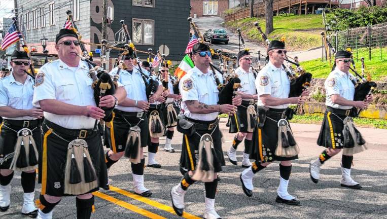 The Police Pipes and Drums of Morris County marches in the parade.