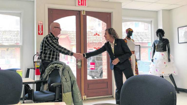 Jane Asselta of the U.S. Agriculture Department shakes hands with Mario Poggi, president of the Sussex Borough Council.