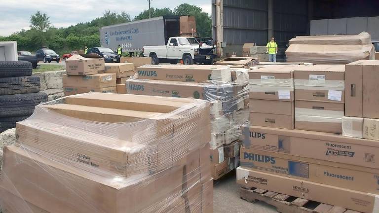 A line of cars behind several pallet loads of fluorescent bulbs (File photo by John Church)