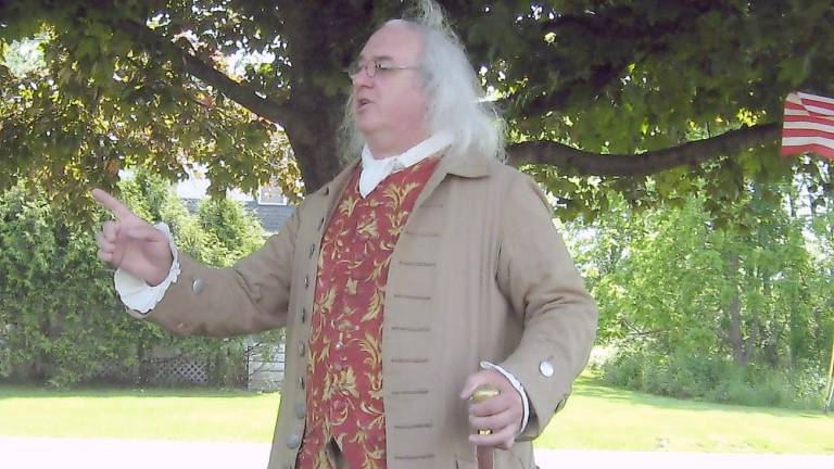 ‘The women of the Revolution saved us’ Robert DeVitis (a.k.a. Benjamin Franklin) makes the crowd chuckle with his humorous observations of the 1770s (Photo by Janet Redyke)