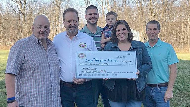 Kevin and Nicole Feeney with Liam accept a check from Sparta UNICO (Photo provided)