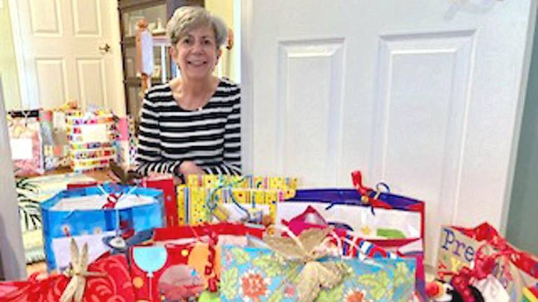 A collection of birthday gift bags is ready to be delivered to residents of the Homestead Rehabilitation and Healthcare Center in Newton by Arleen Hill, co-chair of the Vernon Township Woman’s Club Birthday Bag project (Photo provided)