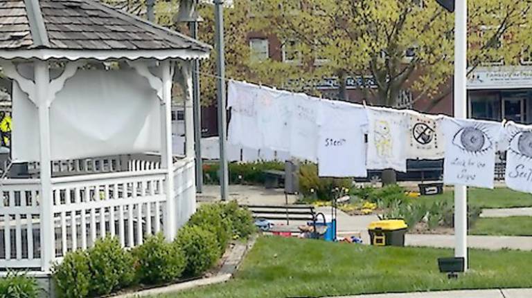 Tee-shirts hanging in the Newton Green help survivors “air out their dirty laundry” (Photo by Laurie Gordon)