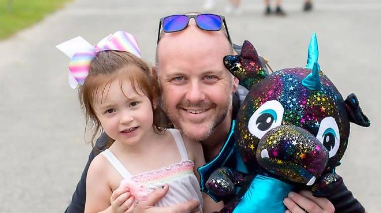 Teagan Carveleyn, 3, of Byram poses with her dad at the fair (Photo by Sammi Finch)