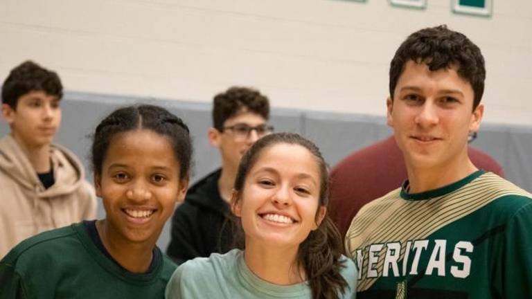 Junior Zoey Torppey was cheered on by the Veritas Christian Academy boys and girls teams.