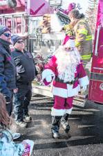 Santa arrives on a fire truck.