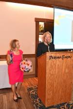WO1 Tammie Horsfield, left, president of the Sussex County Chamber of Commerce, holds the Woman of the Year award for Deborah Berry-Toon, executive director of Project Self-Sufficiency. (Photos by Maria Kovic)