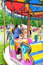 Penelope Ruvo rides the merry-go-round Friday, May 30 at the Firemen’s Carnival in Oak Ridge. (Photos by Maria Kovic)